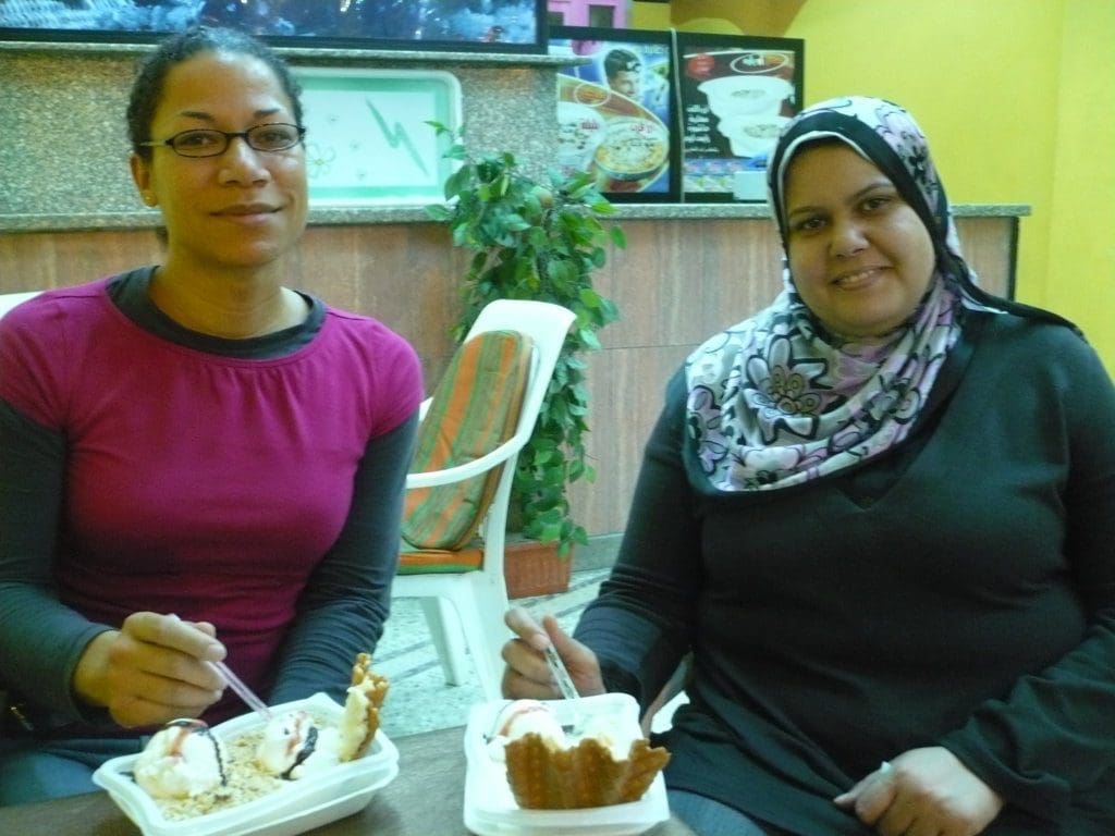 a photo of two females enjoying rice ice cream in Alexandra, Egypt.