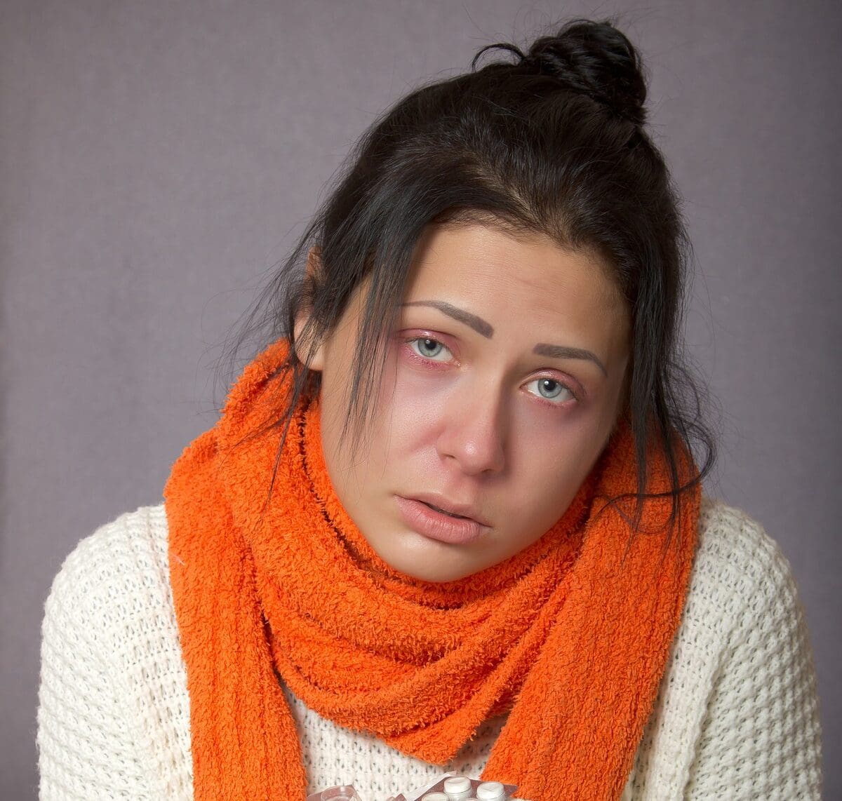 woman holding pills from a rebound headache