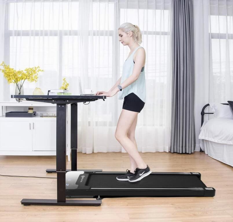 An image of a woman on an under the desk treadmill
